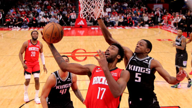 Rockets forward Tari Eason scores inside against Sacramento Kings guard De'Aaron Fox (5) during the fourth quarter at Toyota Center.